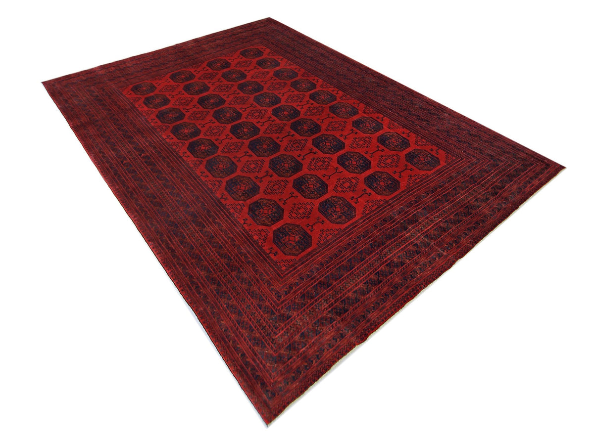 Hand-knotted vintage Turkmen Ersari rug in deep madder red with repeating indigo elephant's foot gul medallions.