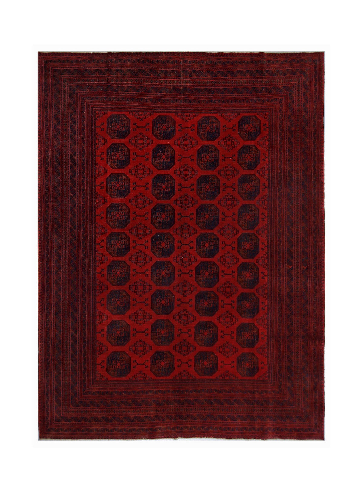 Hand-knotted vintage Ersari rug featuring a deep red field with repeating dark blue elephant’s foot gul medallions.