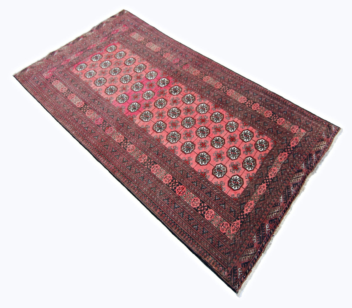Vintage Turkmen Mauri rug in deep madder red with repeating gul medallions, fine wool pile, and intricate indigo borders.