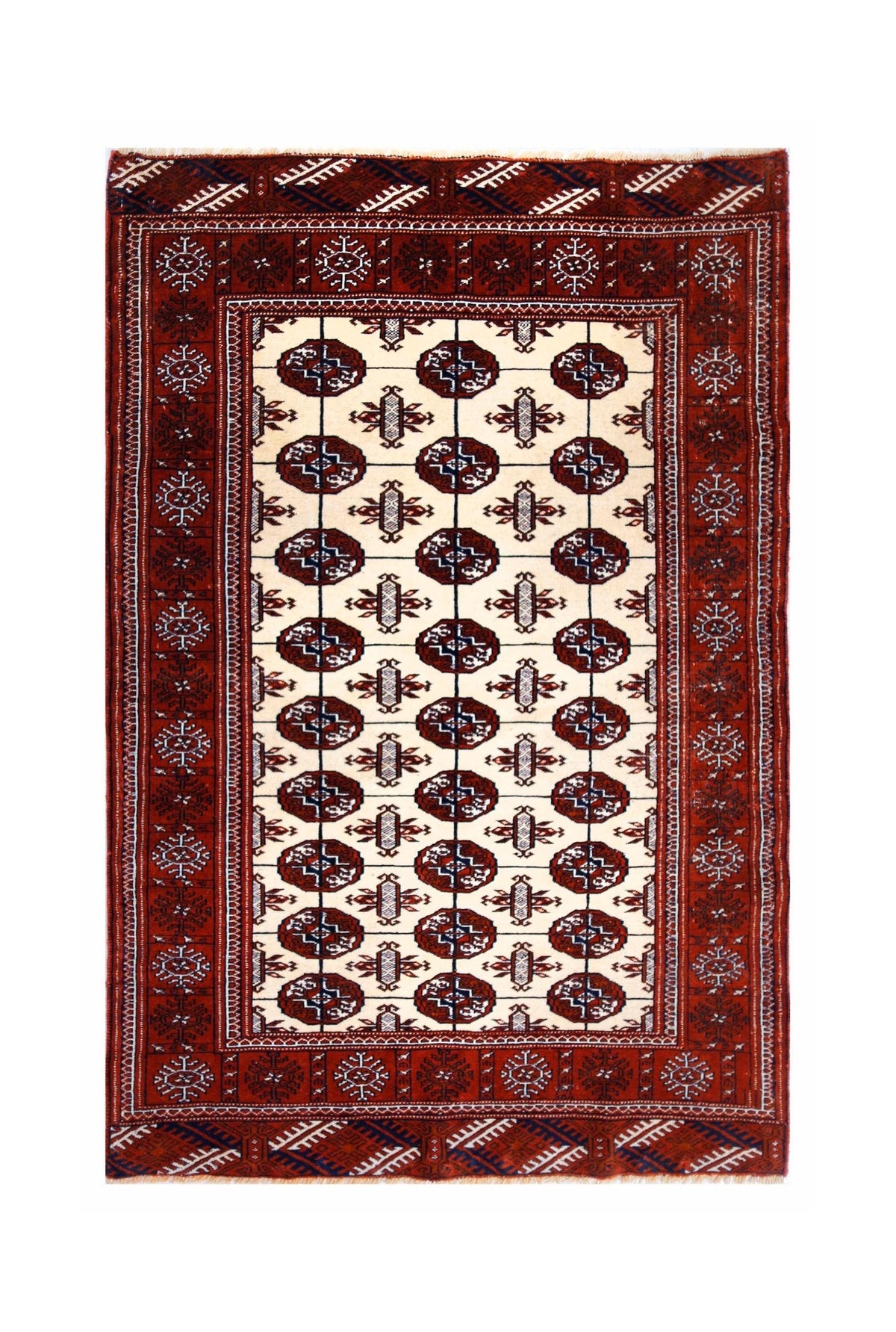 Vintage Tekke rug featuring repeating octagonal guls in deep red, ivory, and indigo blue with a fringed edge.