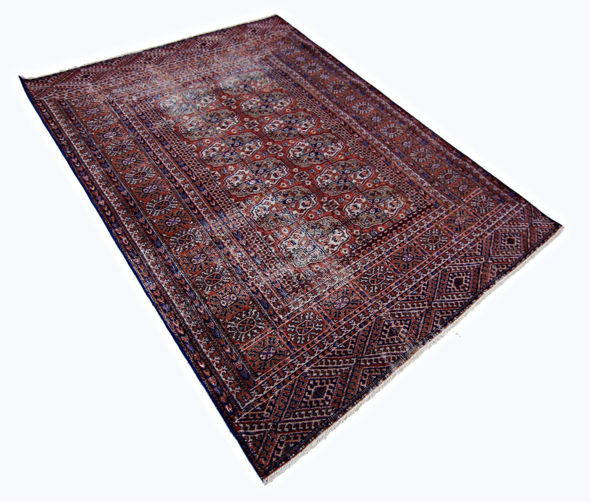 Vintage Turkmen Tekke rug with a deep red field, repeating octagonal gul medallions, and intricate indigo and ivory details.