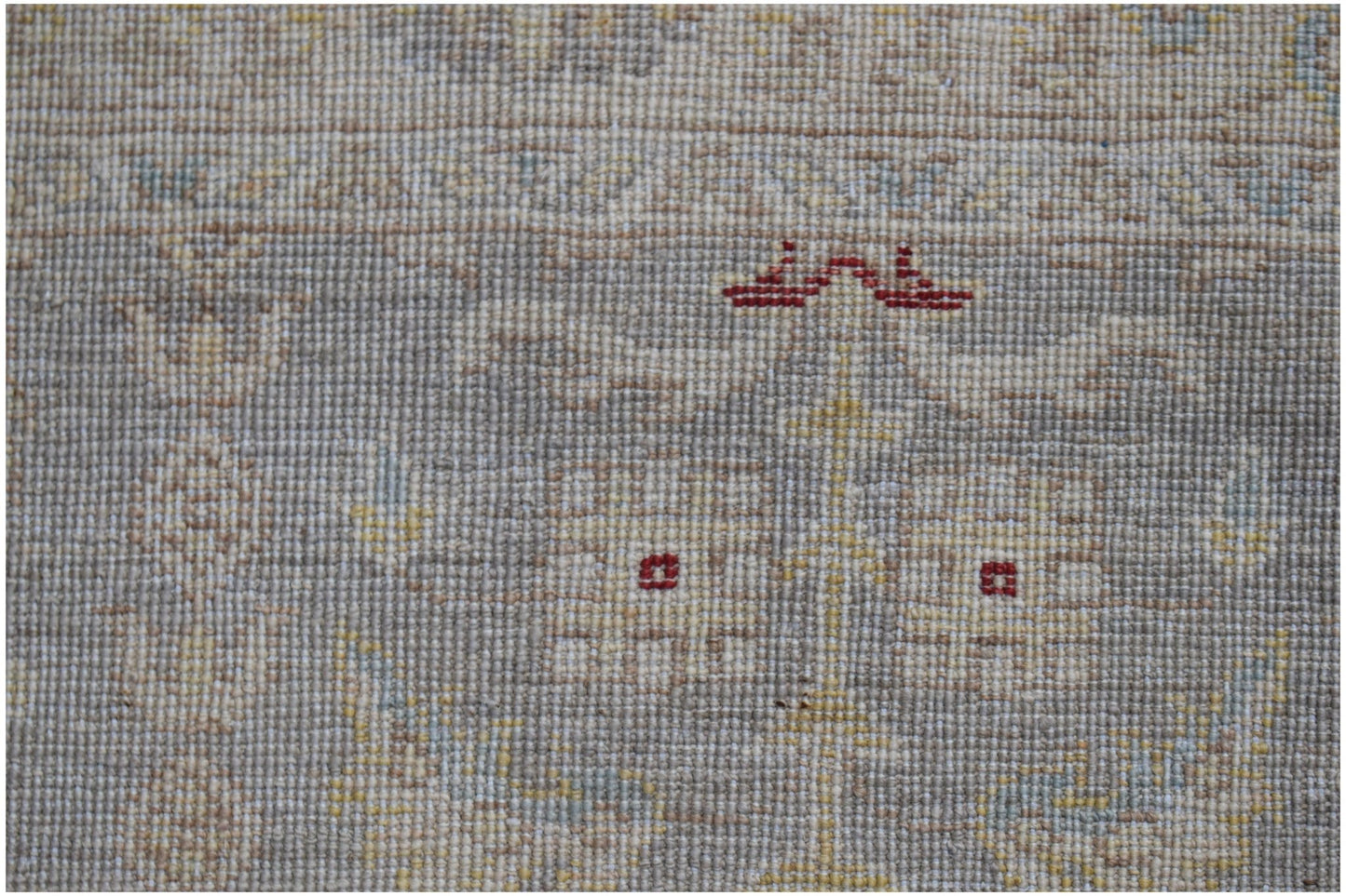 A close-up of a hand-knotted Afghan Chobi runner featuring traditional patterns in earthy tones.