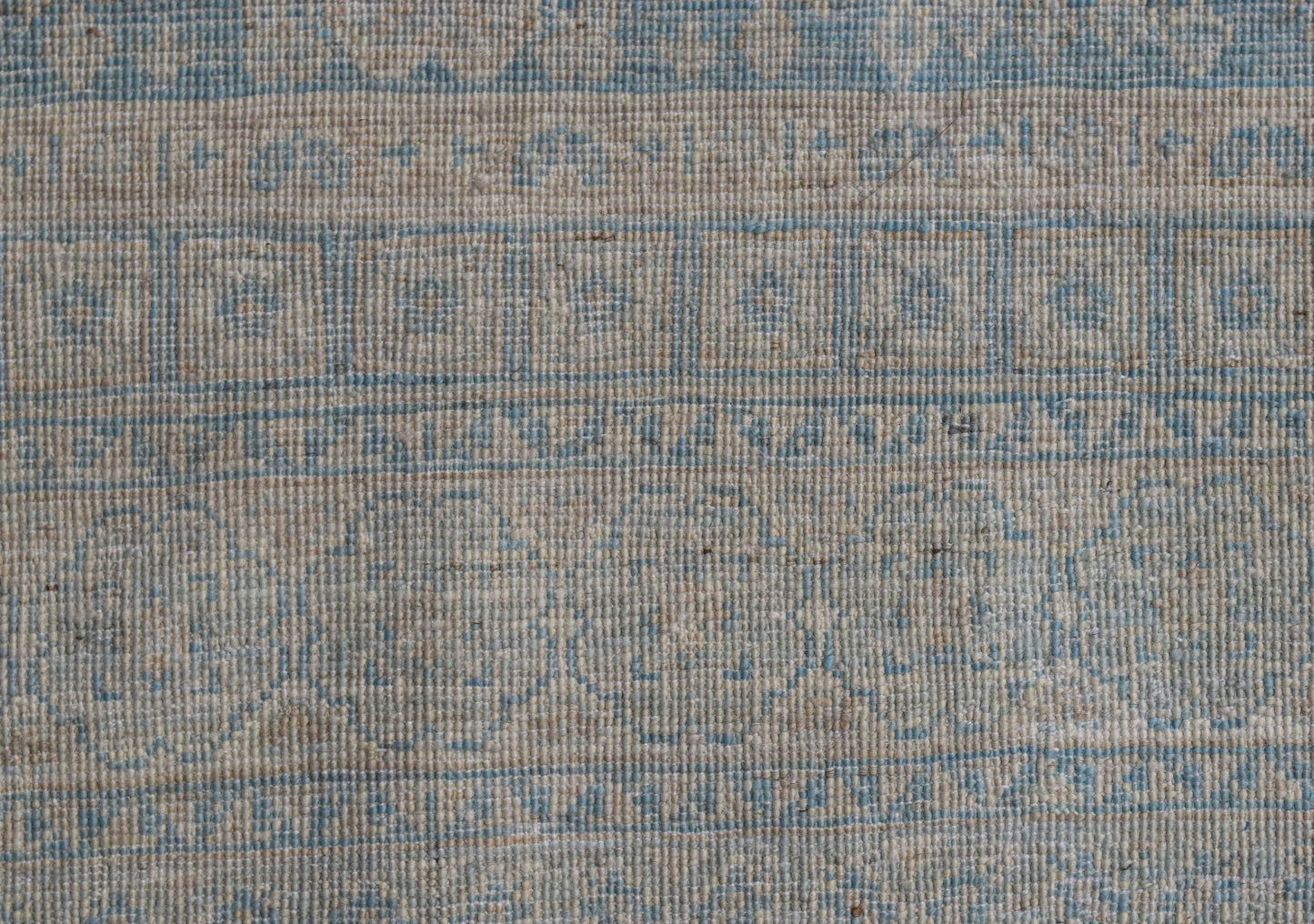 A handwoven Afghan Chobi runner featuring a traditional blue and beige Mamluk geometric pattern.