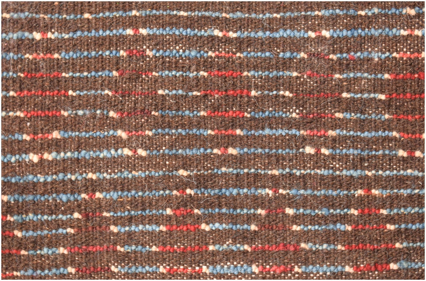 A brown hand-knotted wool rug featuring horizontal stripes of blue, red, and cream accents.