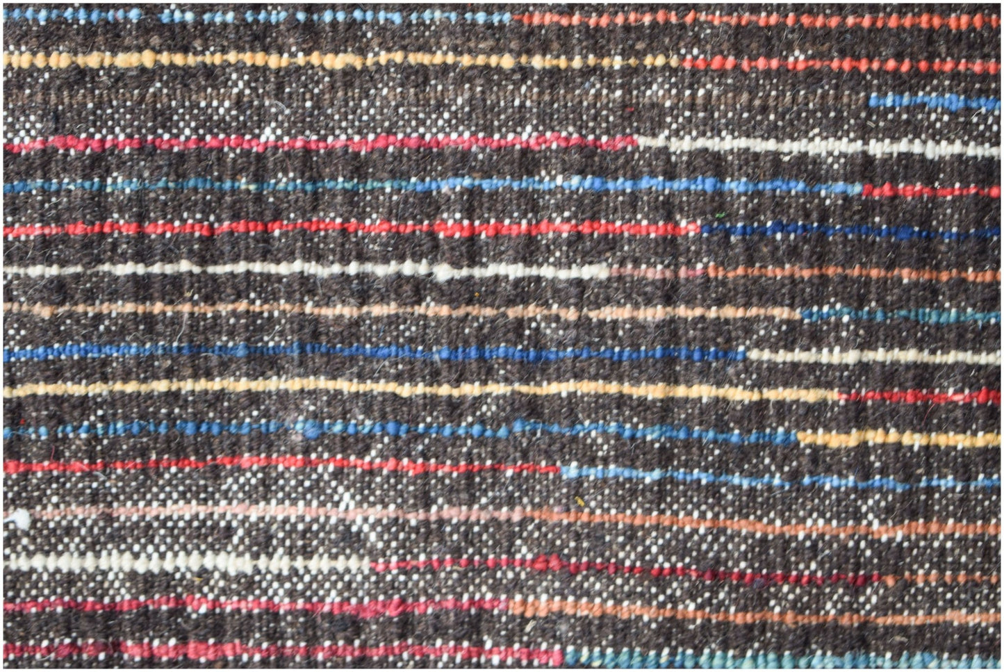 A hand-knotted Afghan rug featuring a dark brown base with horizontal stripes in vibrant colors.
