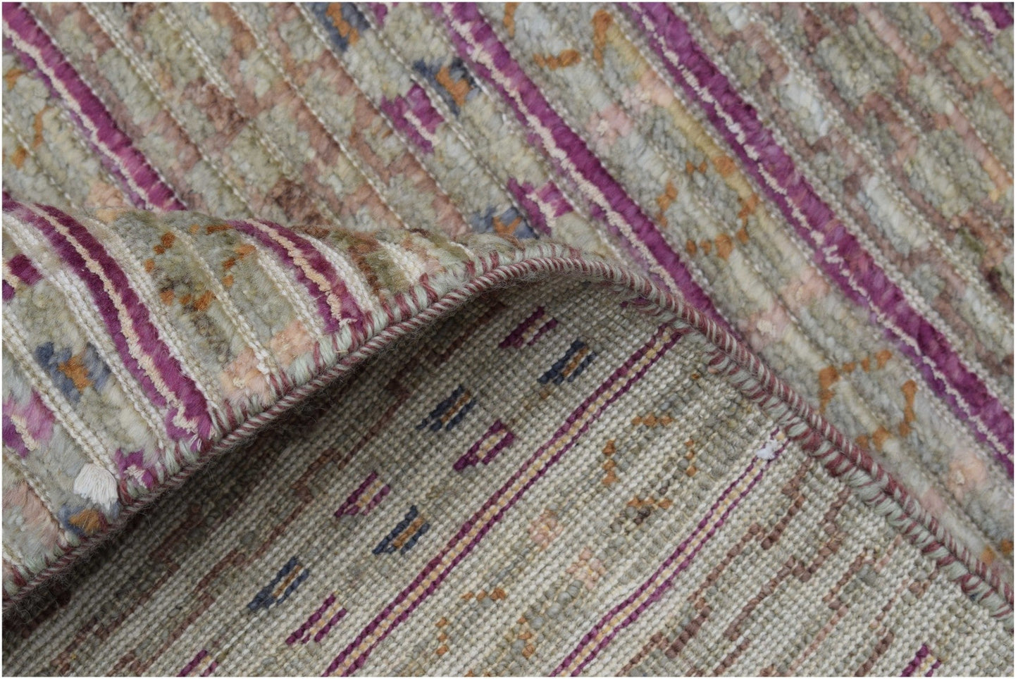 A handmade Afghan Yekta rug featuring a textured blend of purple and neutral striped patterns.