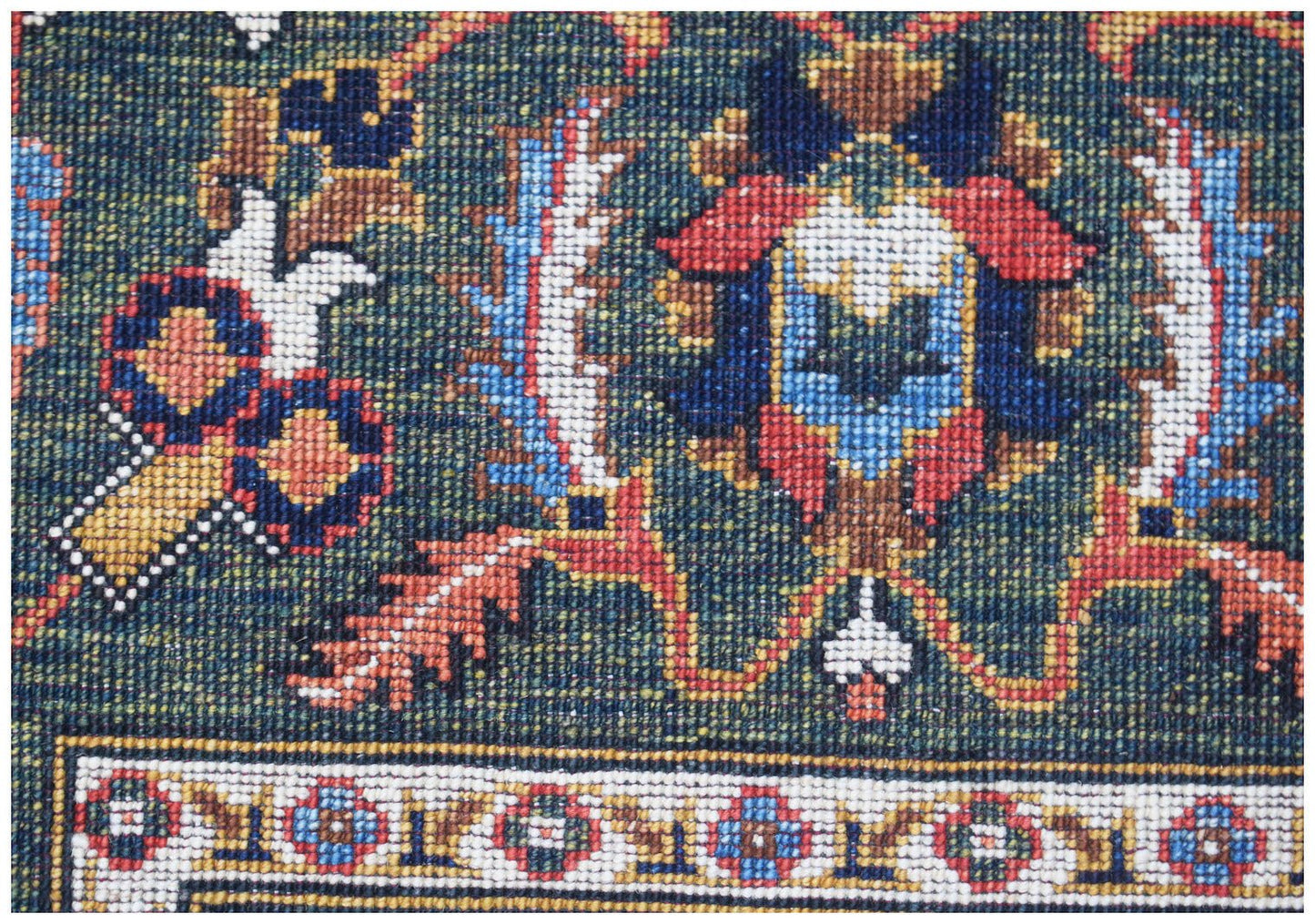 A close-up of a handwoven Afghan Chobi rug featuring intricate floral patterns in earthy tones.