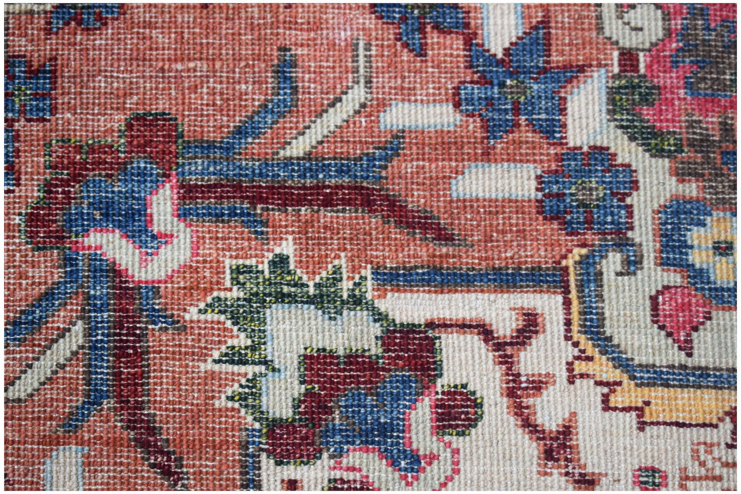 A close-up of a handwoven Afghan Chobi rug featuring intricate floral patterns in earthy tones.