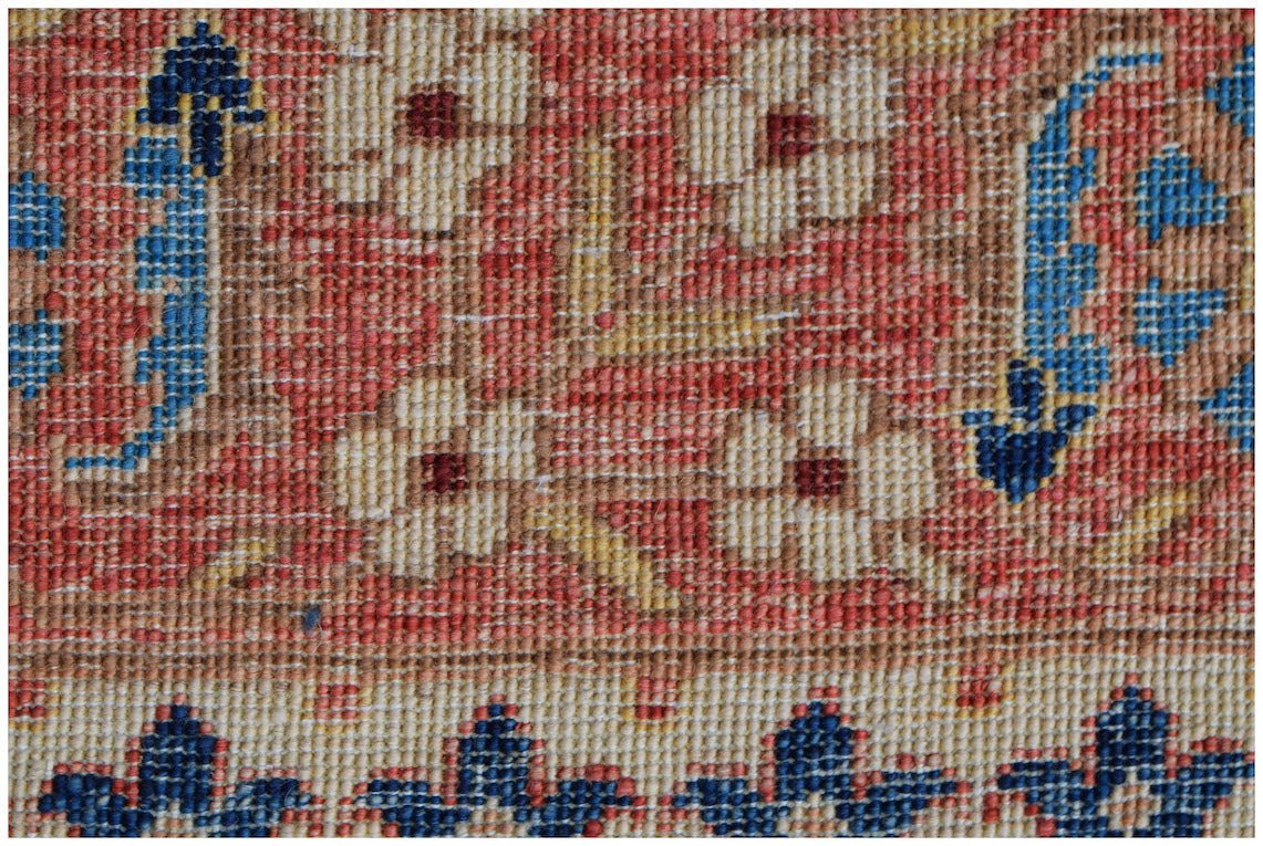 A close-up of a handmade Afghan Balkh rug featuring floral patterns in red, blue, and cream.