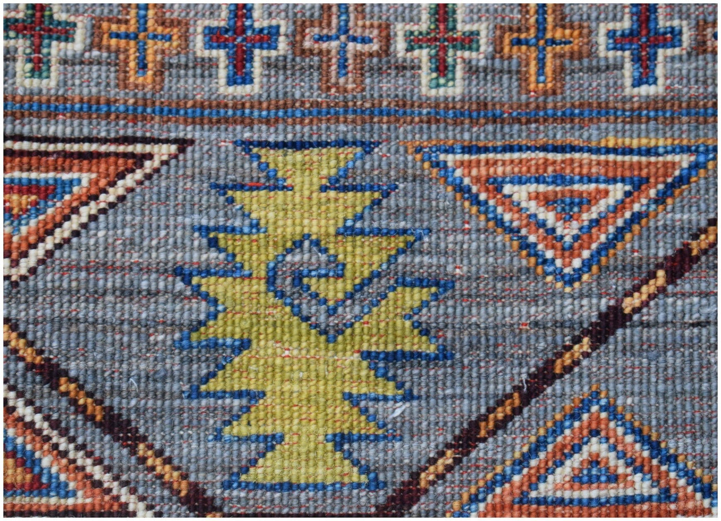 Handmade Afghan Chobi rug featuring a geometric pattern with blue, orange, and yellow motifs.