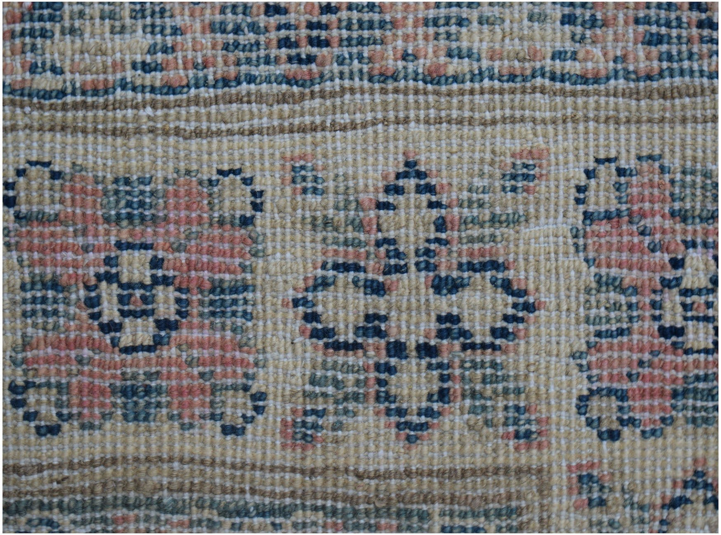 A close-up of a handmade Afghan Kazakh runner featuring traditional geometric motifs in wool.