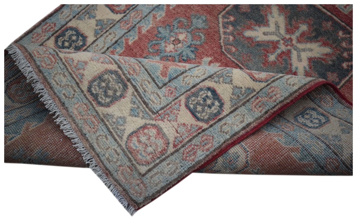 A handmade Afghan Kazakh runner featuring traditional geometric motifs in red, blue, and cream.
