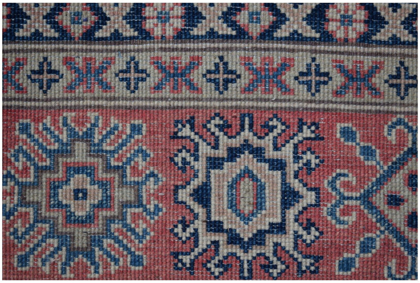 Handmade Afghan Kazakh rug featuring traditional geometric motifs in red, blue, and beige wool.