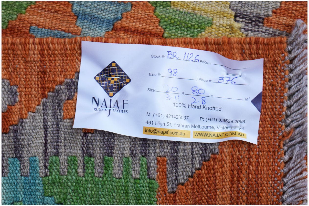 A handmade Afghan Maimana kilim featuring a vibrant geometric pattern in orange, green, and blue.