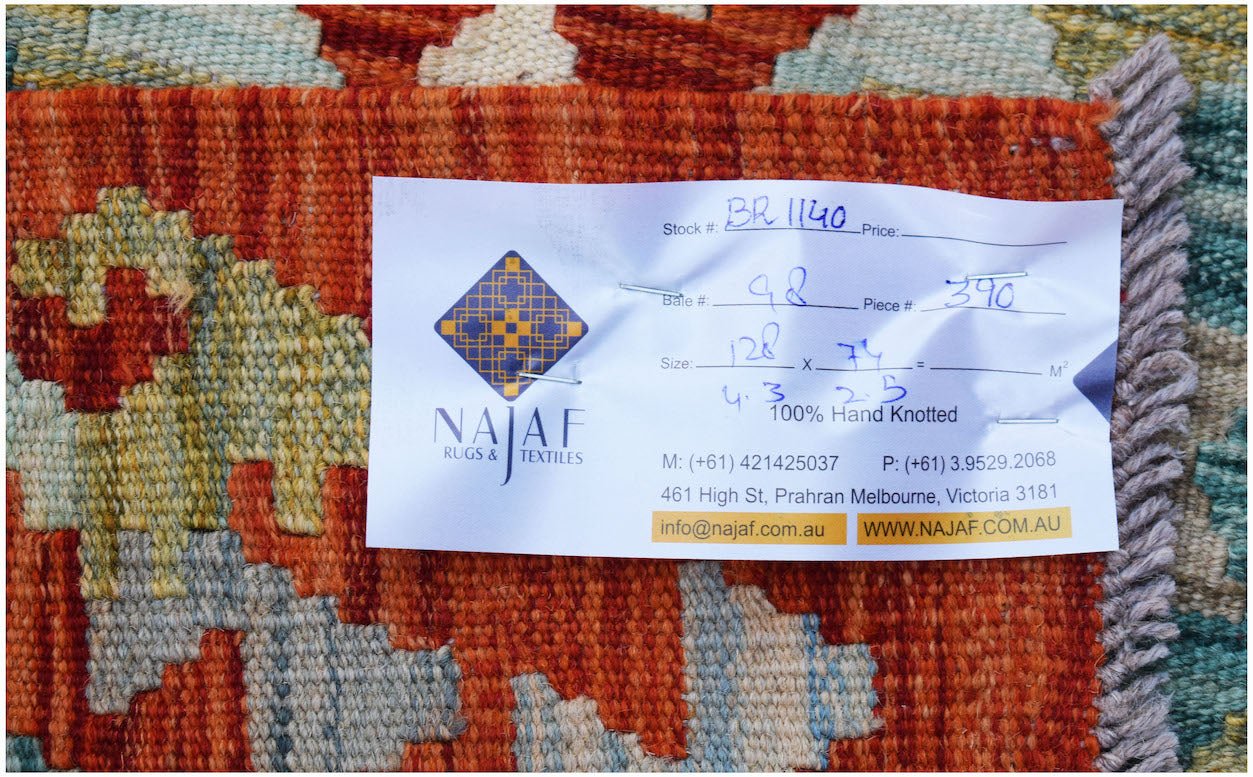 A hand-knotted Afghan Maimana kilim featuring a geometric pattern in shades of orange and blue.