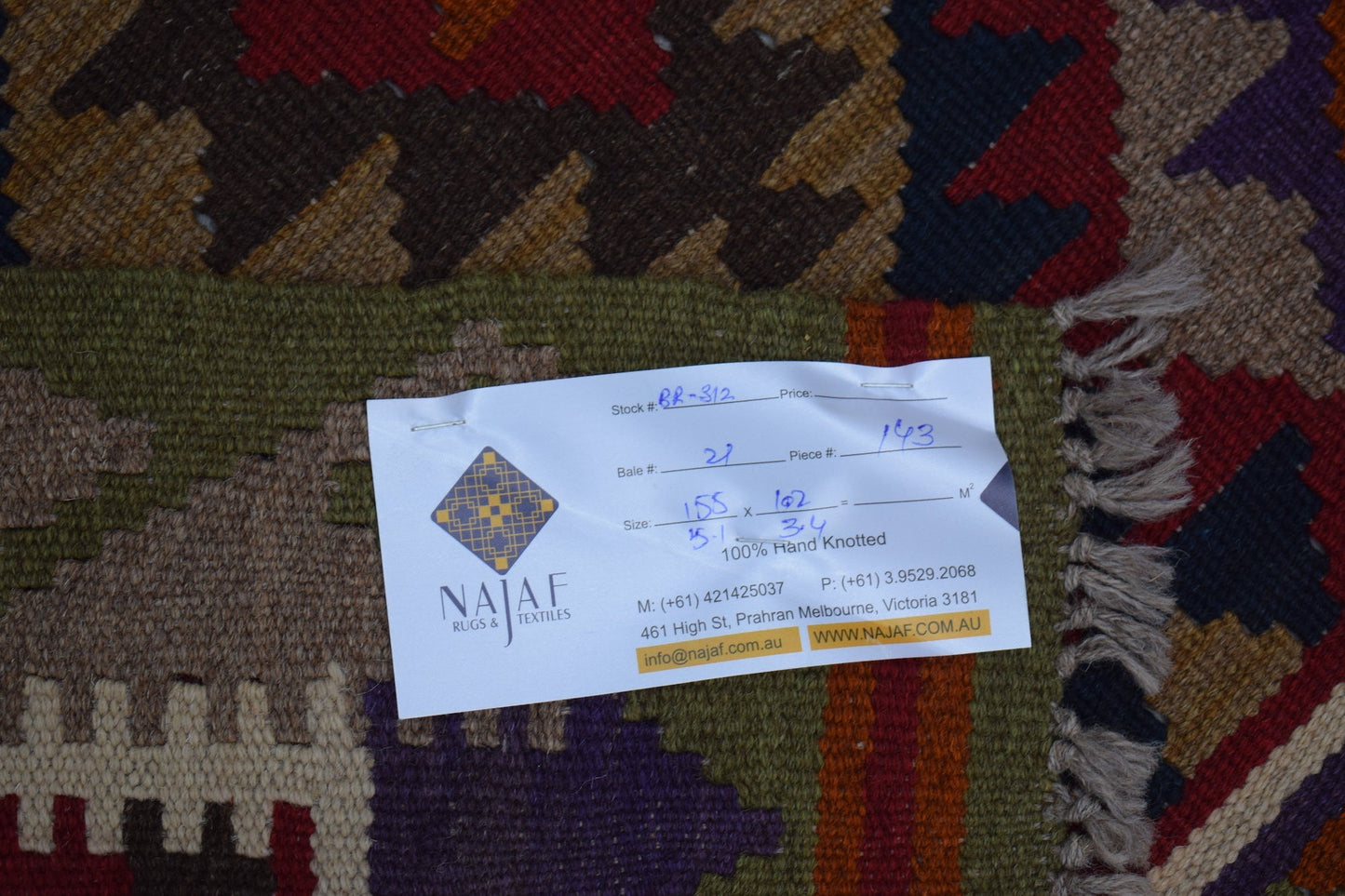 A handmade Afghan Maimana kilim featuring a geometric pattern in rich, earthy tones.