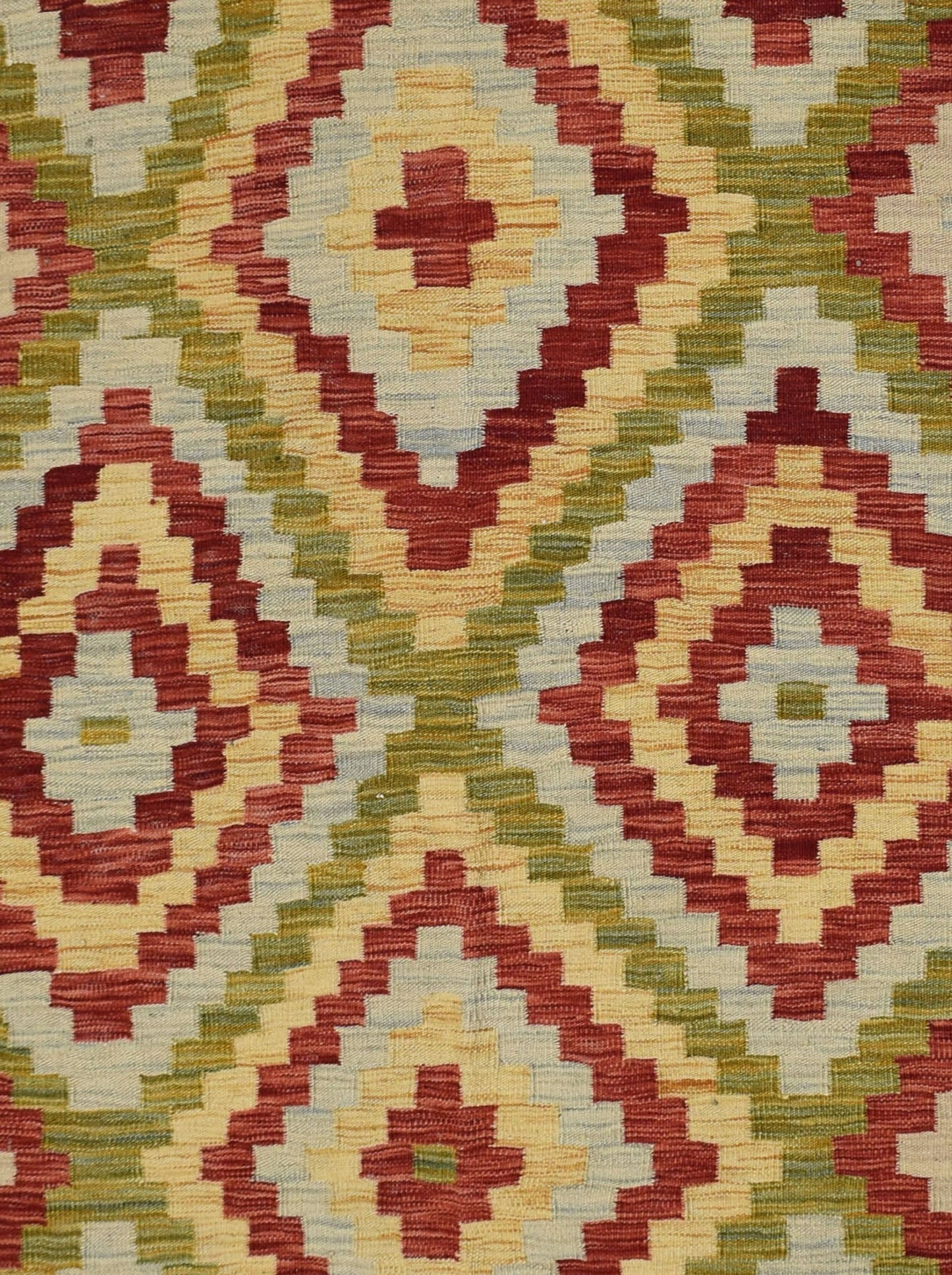 Handmade Afghan Maimana kilim rug featuring a geometric diamond pattern in red, green, and cream.