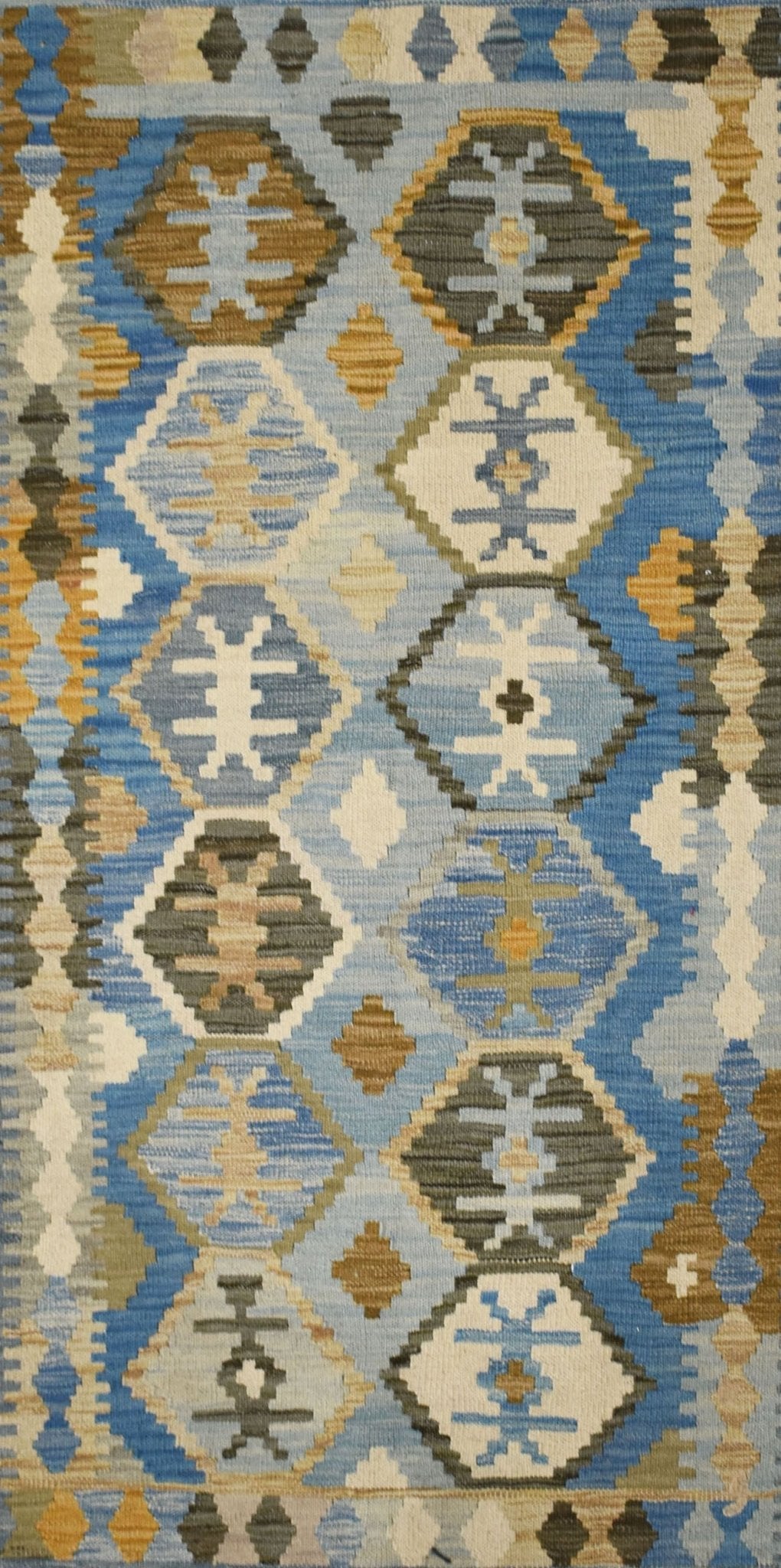 Handmade Afghan Maimana kilim rug featuring a geometric pattern in shades of blue, tan, and grey.