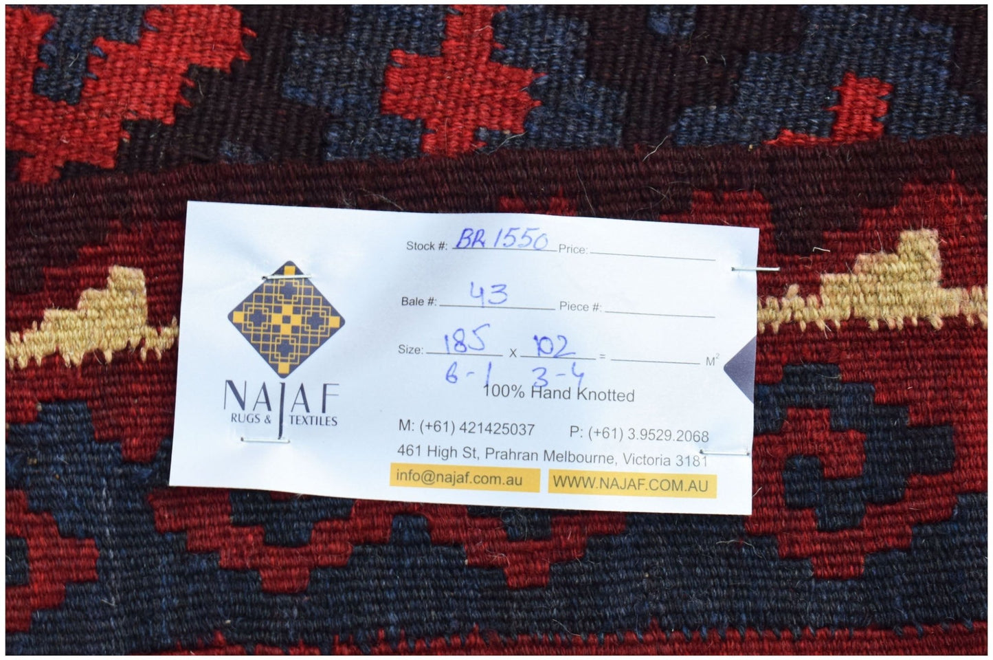 A handwoven Afghan Maimana kilim featuring a geometric pattern in red, blue, and cream wool.