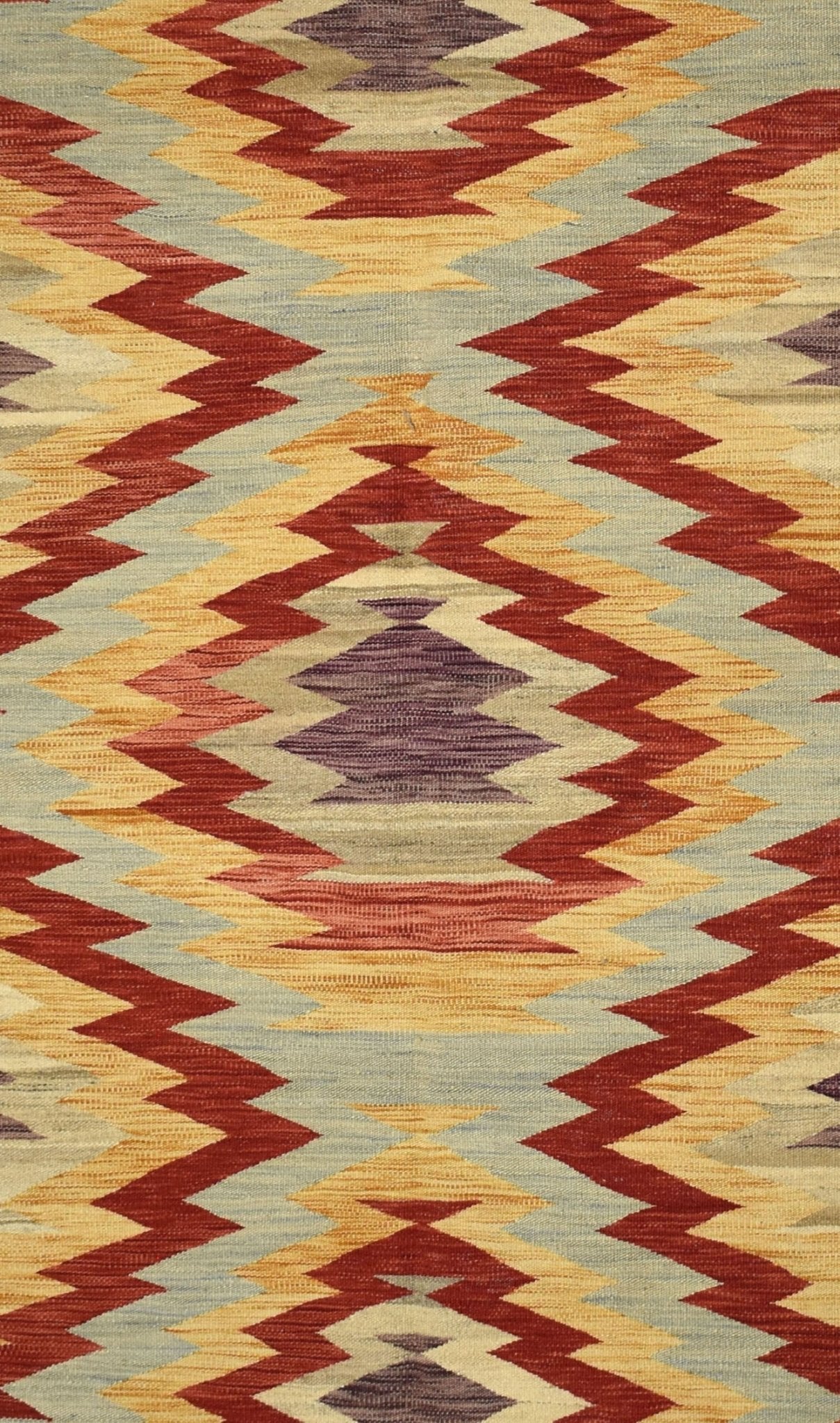 Handmade Afghan Maimana kilim rug featuring a geometric zigzag pattern in earthy tones.