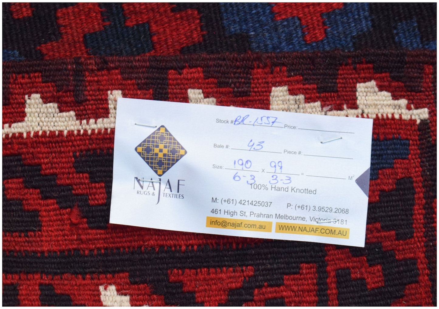A handwoven Afghan Maimana Kilim featuring a geometric pattern in red, blue, and cream wool.
