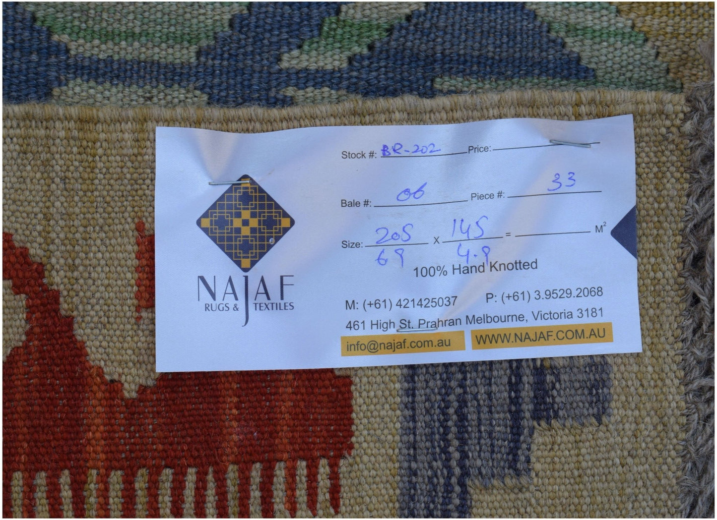 A handwoven Afghan Maimana Kilim rug featuring a flatweave texture and geometric patterns.