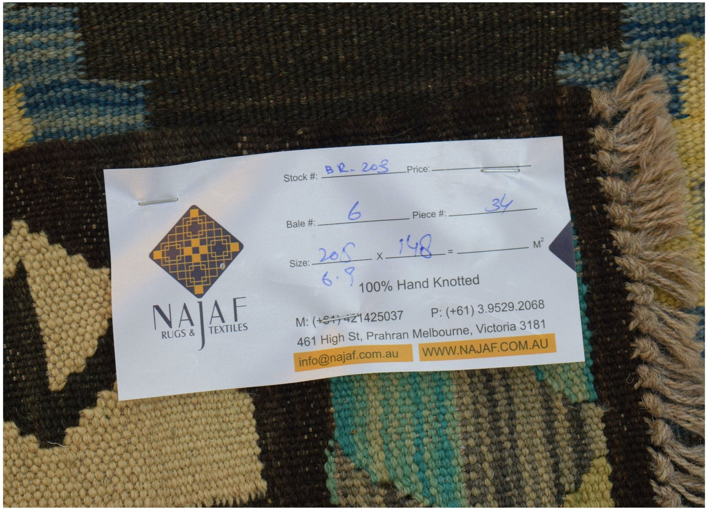An Afghan Maimana kilim rug featuring a geometric pattern in shades of brown, blue, and cream.