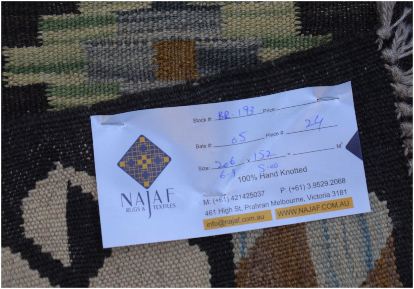 A handwoven Afghan Maimana Kilim featuring a geometric pattern in earthy tones.
