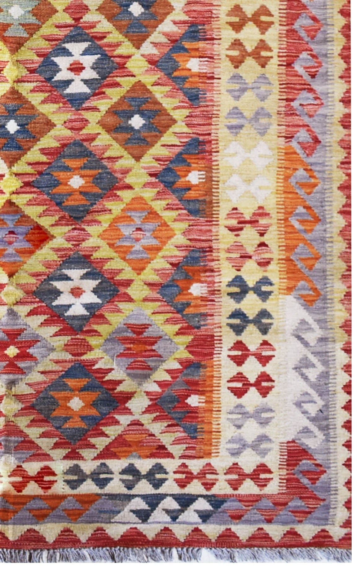 Handmade Afghan Maimana kilim rug featuring a vibrant geometric diamond pattern in wool.