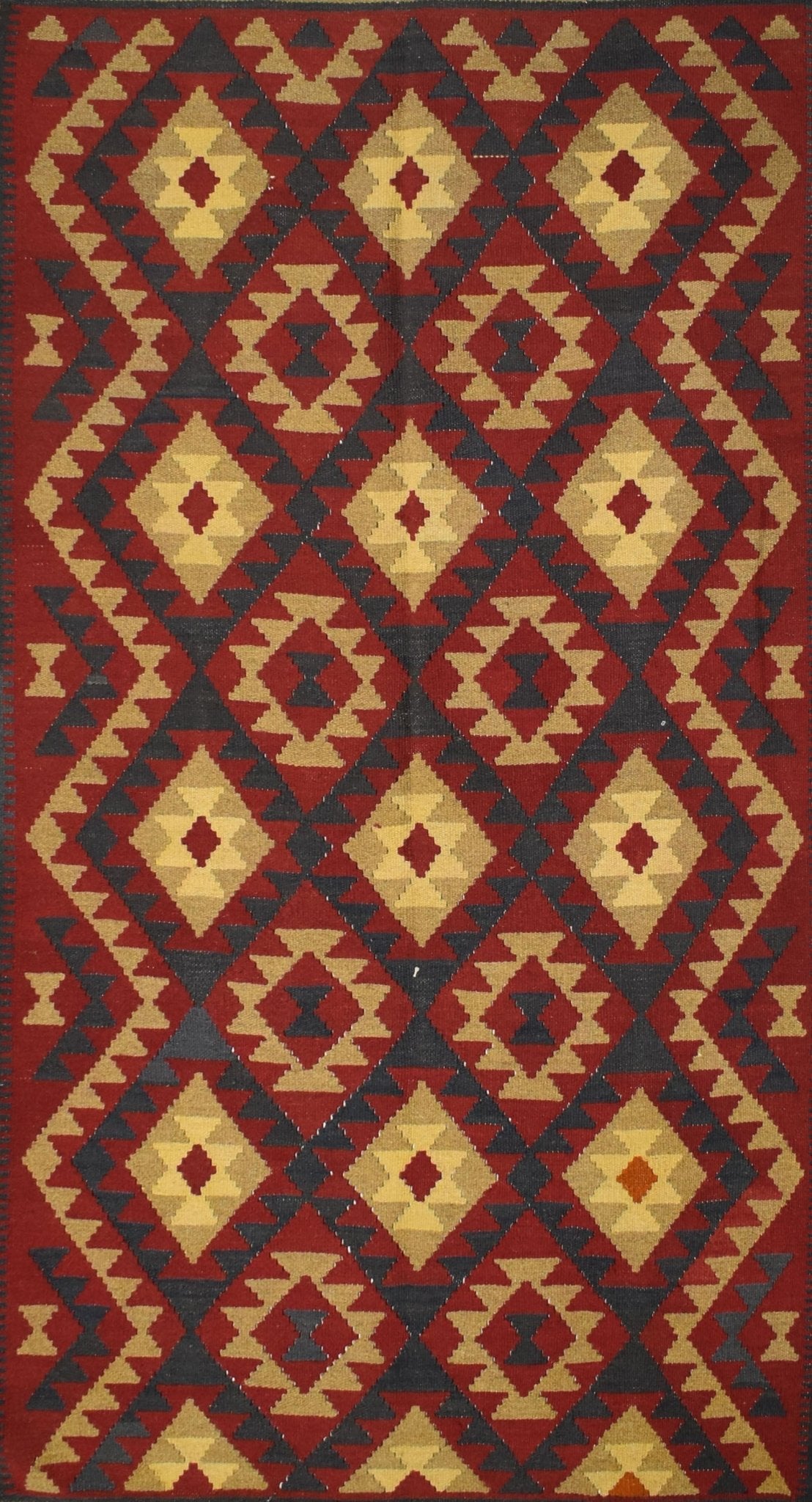 Handmade Afghan Maimana kilim rug featuring a geometric diamond pattern in red, tan, and charcoal.