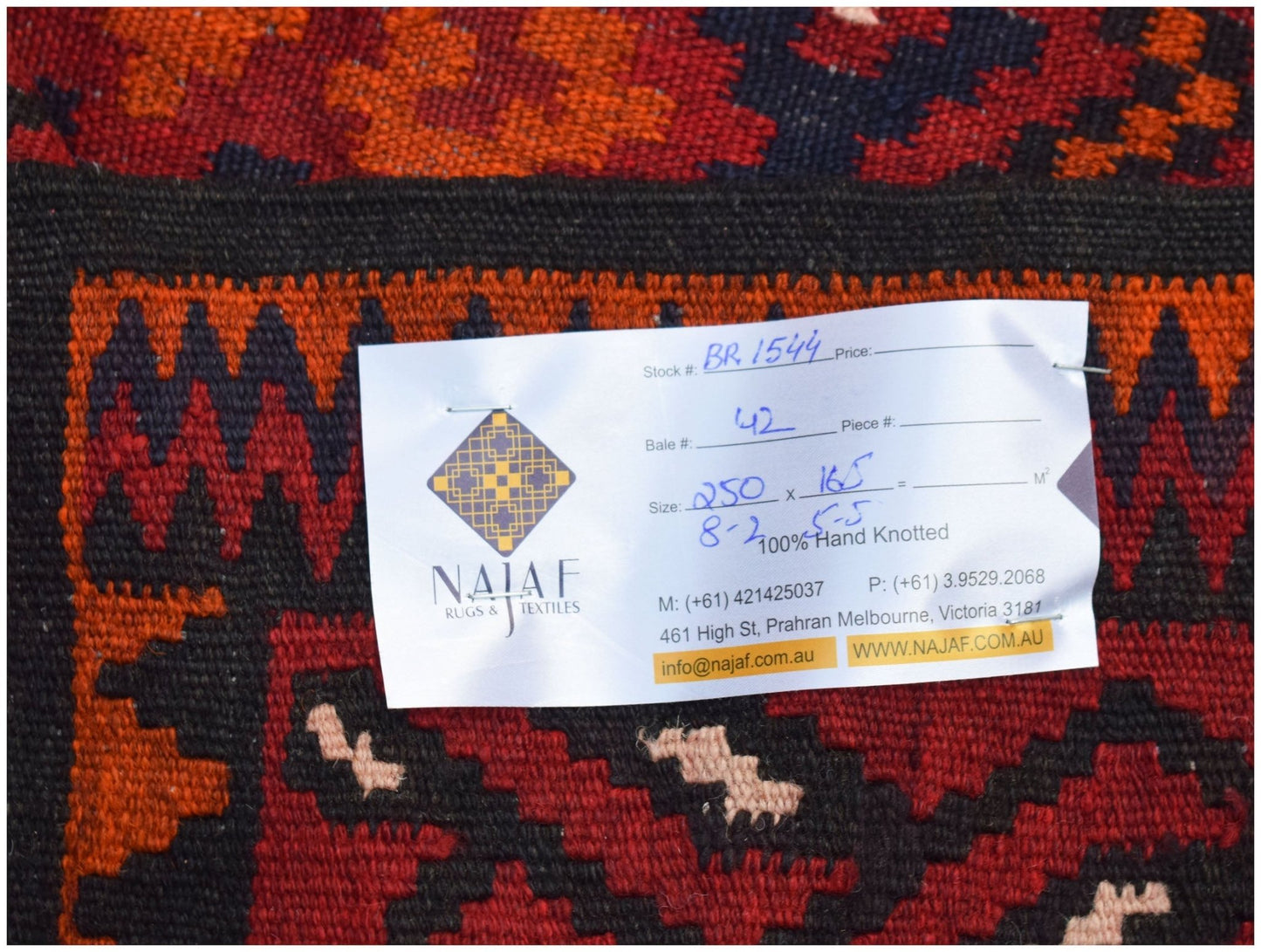 A handwoven Afghan Maimana Kilim featuring a geometric pattern in shades of red and black.
