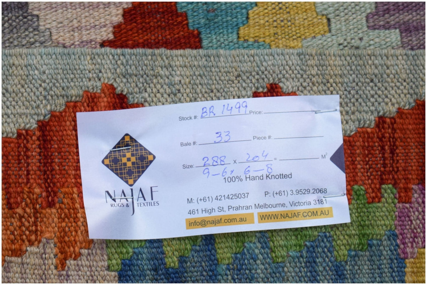 An Afghan Maimana Kilim rug featuring a vibrant geometric pattern in wool.