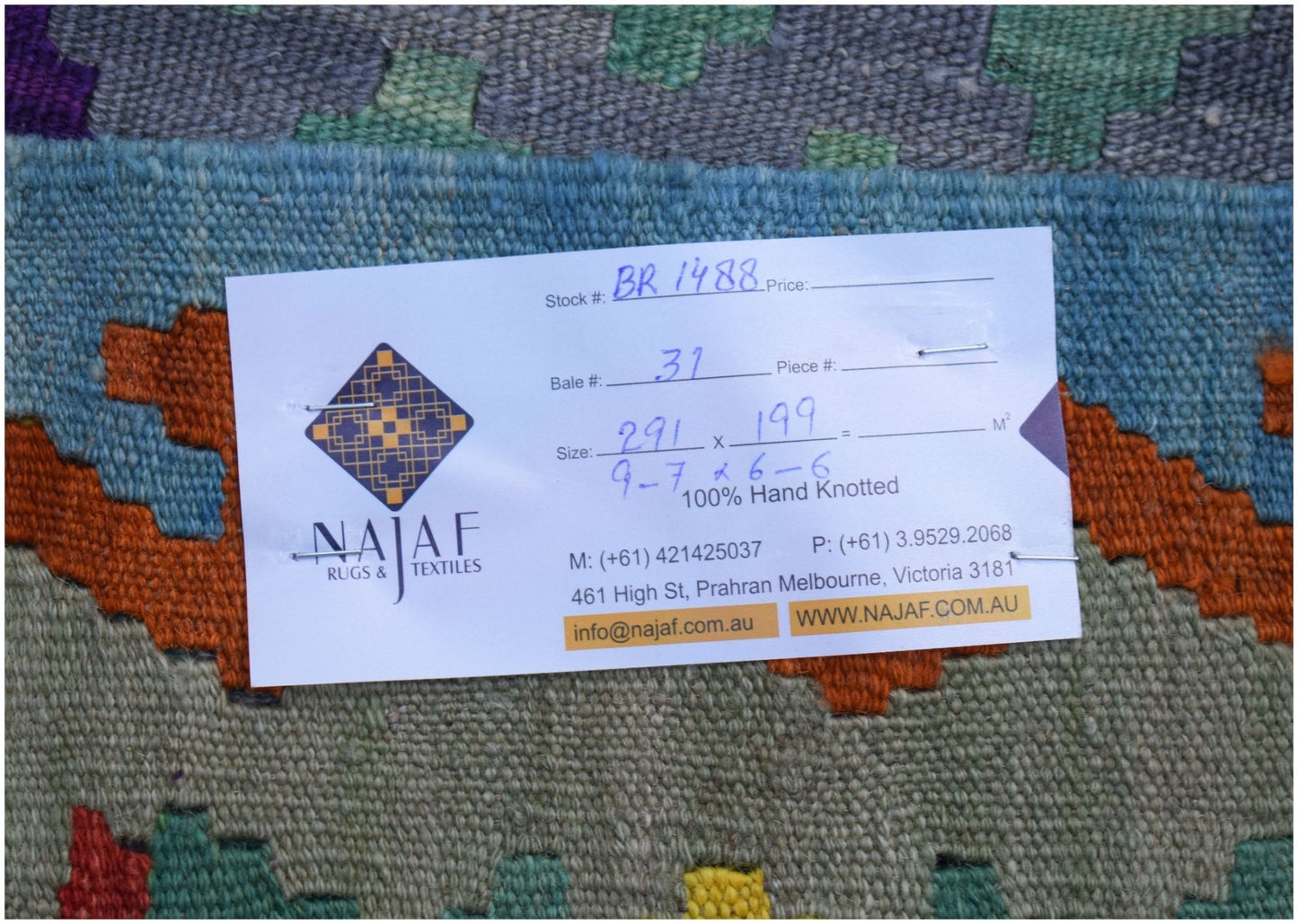 An Afghan Maimana Kilim rug featuring a geometric pattern in blue, orange, green, and purple.