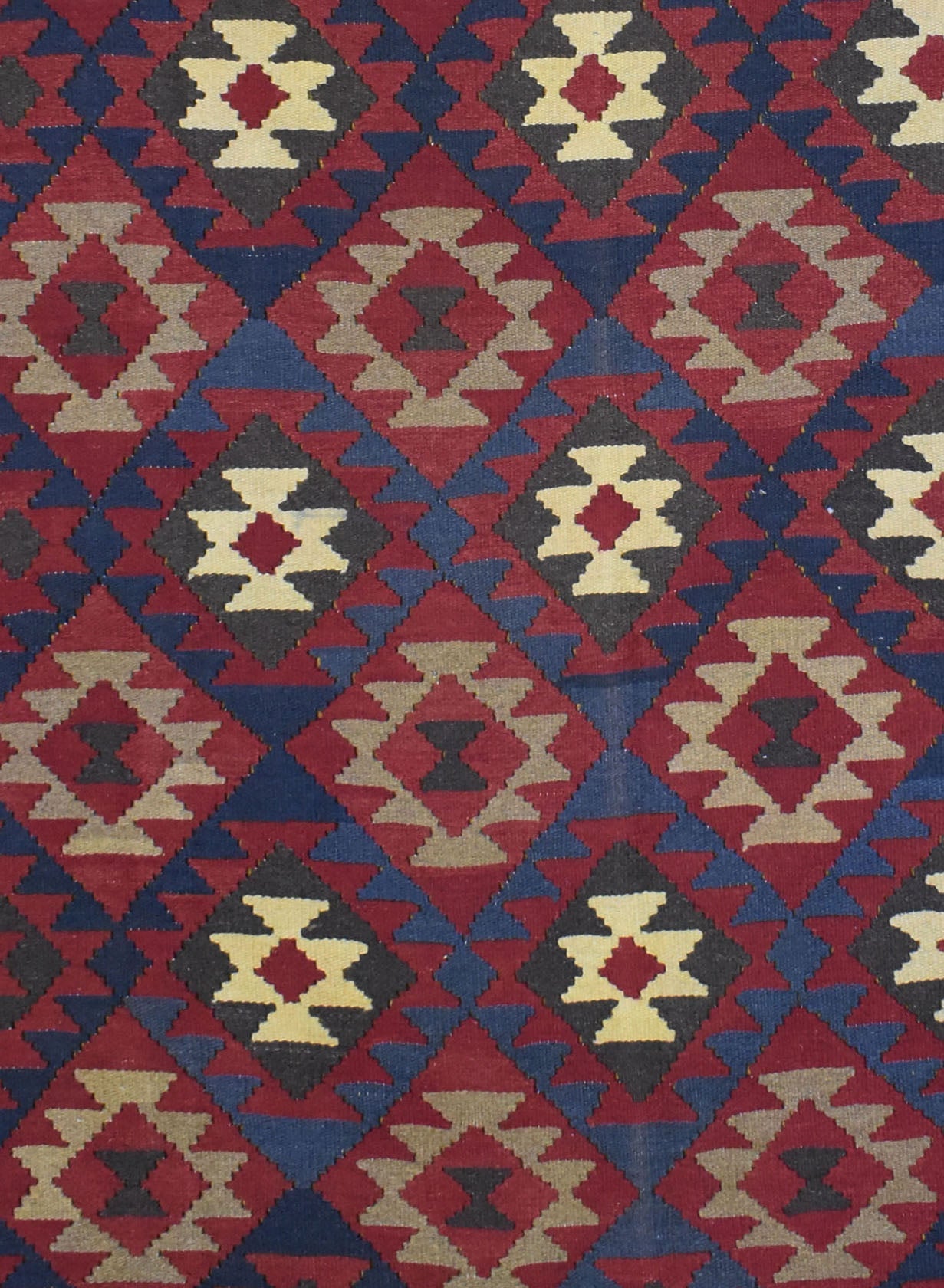 Handmade Afghan Maimana kilim rug featuring a repeating geometric diamond pattern in red and blue.