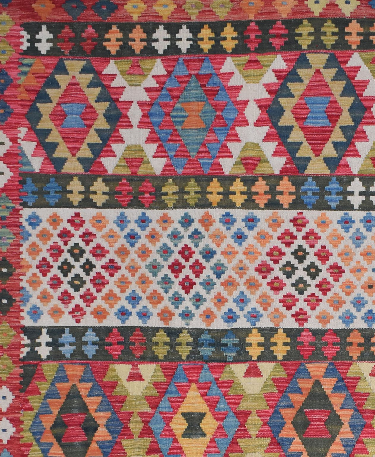 Handmade Afghan Maimana kilim rug featuring a vibrant geometric pattern in wool.