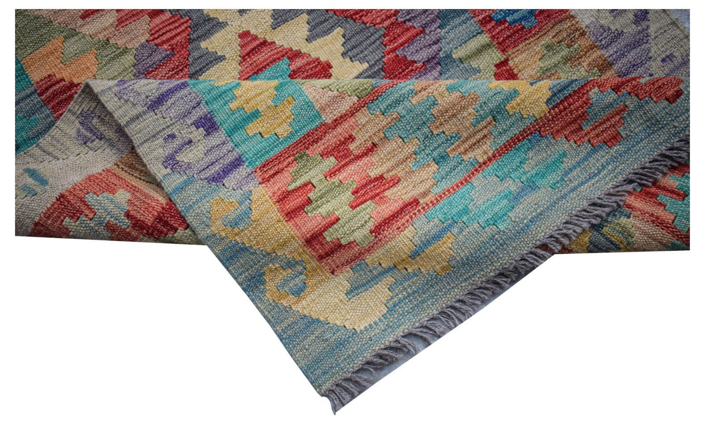 Handwoven Afghan Maimana wool runner featuring a colorful geometric pattern and fringed edges.