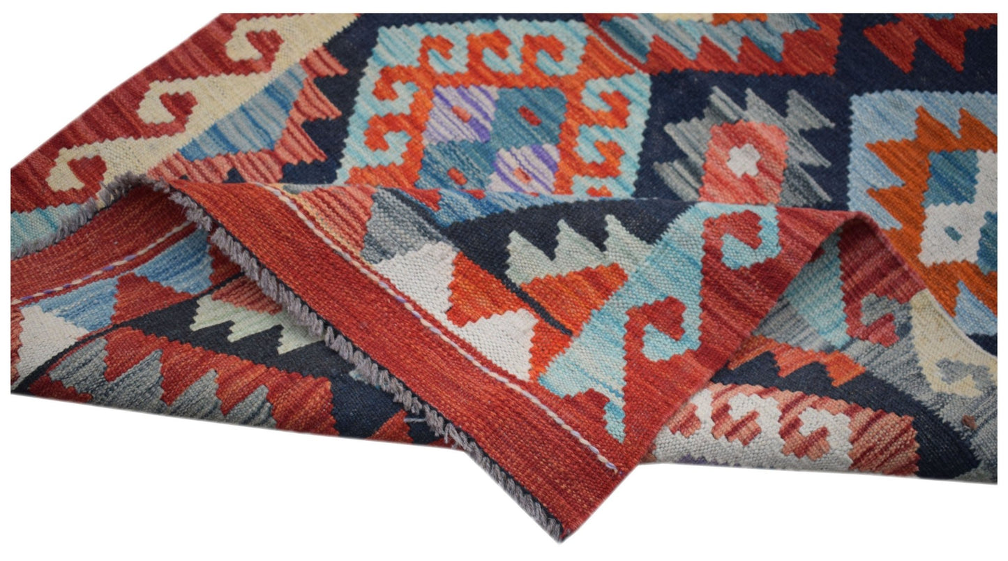 Handwoven Afghan Maimana wool kilim runner featuring a vibrant geometric pattern.