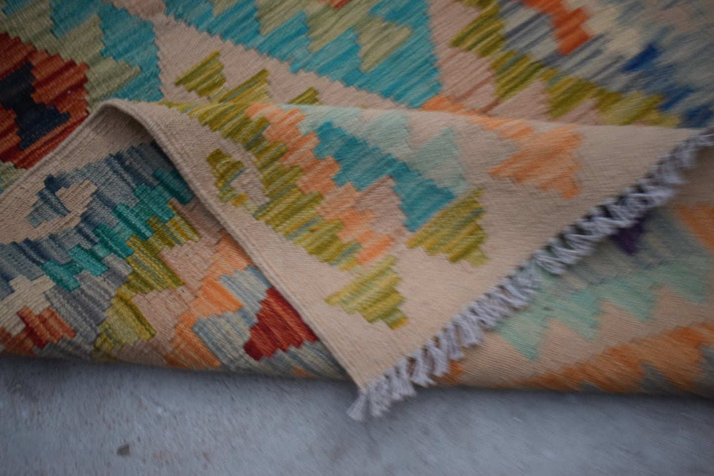 Handwoven Afghan Maimana wool kilim runner featuring a geometric pattern in vibrant colors.