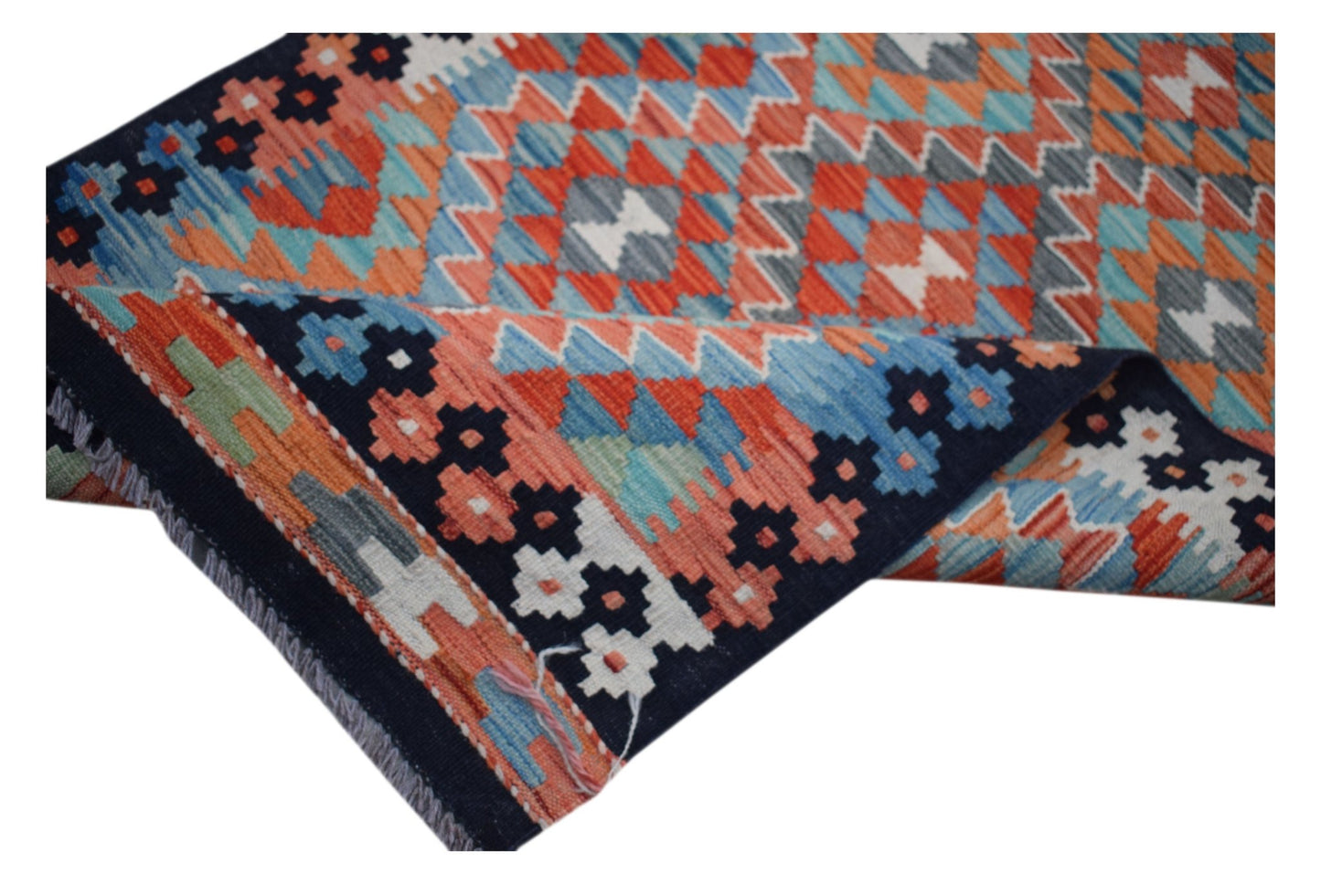 A handwoven Afghan Maimana kilim runner featuring a vibrant geometric pattern in wool.