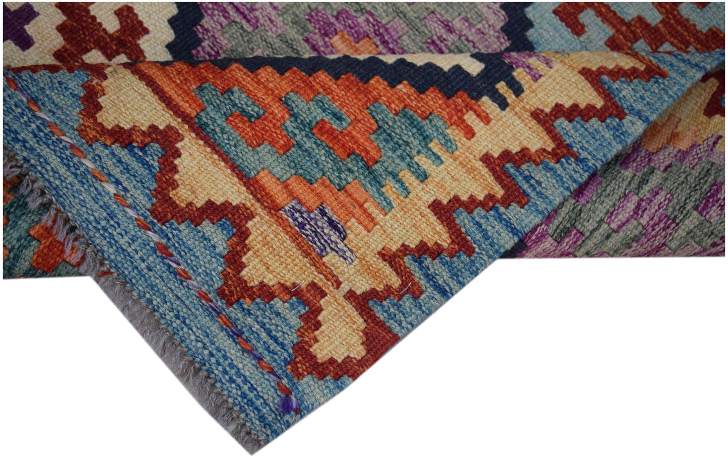 A handwoven Afghan Maimana wool kilim runner featuring a vibrant geometric pattern.