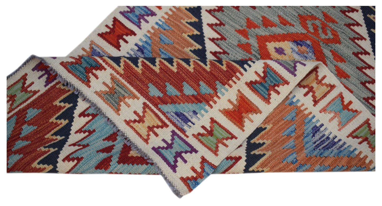 A handwoven Afghan Maimana wool runner featuring a colorful geometric pattern.