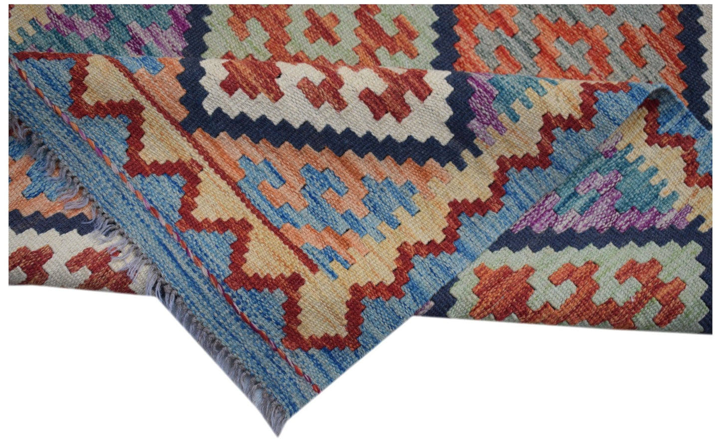 A handmade Afghan Maimana wool kilim runner featuring a colorful geometric pattern.