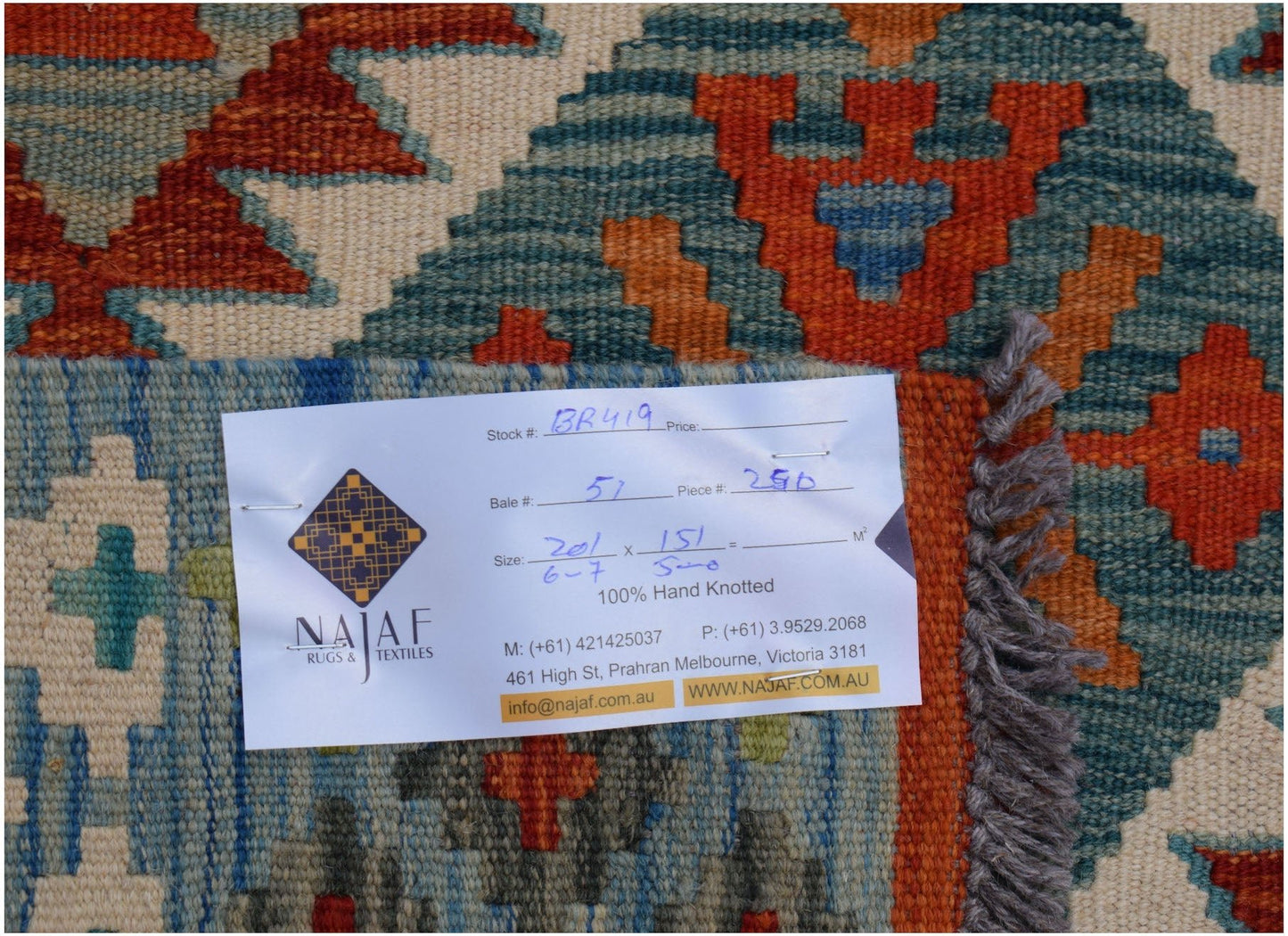 An Afghan Maimana Kilim rug featuring geometric patterns in orange, blue, and cream tones.