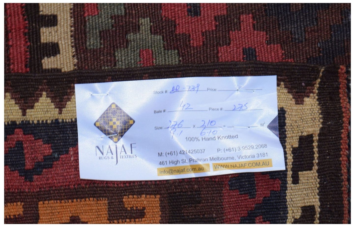 A handwoven Afghan Maimana kilim featuring a geometric pattern in rich red, brown, and tan tones.