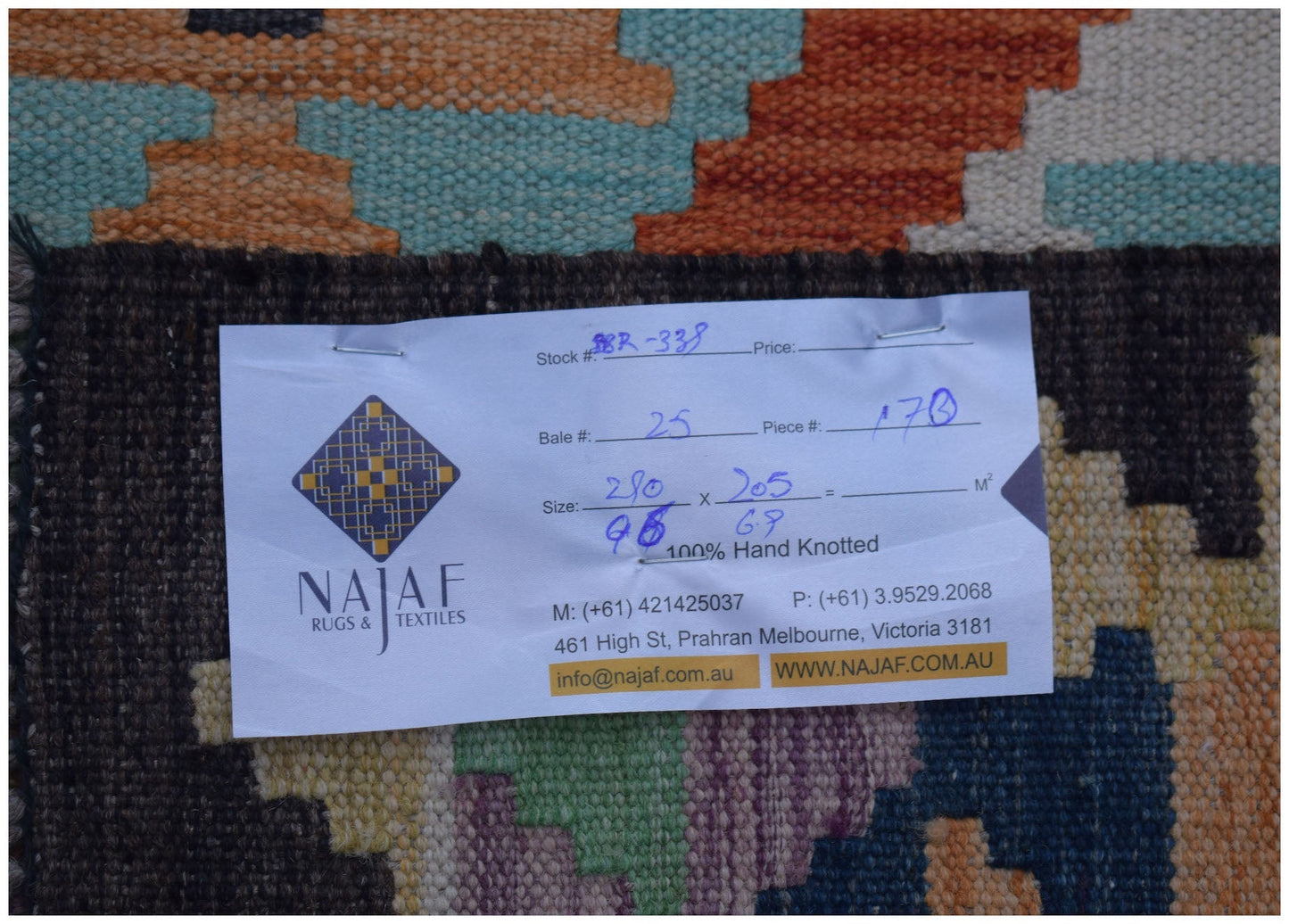 A handwoven Afghan Maimana kilim rug featuring a vibrant geometric pattern in wool.