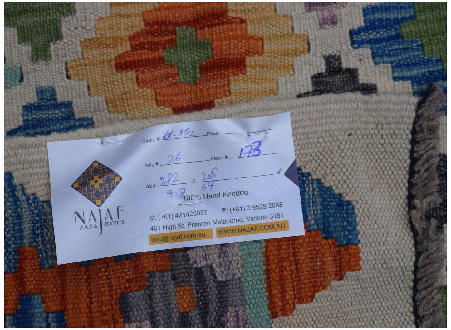 An Afghan Maimana kilim rug featuring a colorful geometric pattern and a flatweave texture.