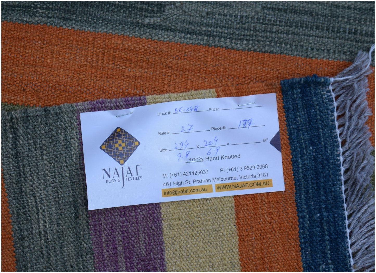 An Afghan Maimana kilim rug featuring a flatweave texture with colorful geometric stripes.