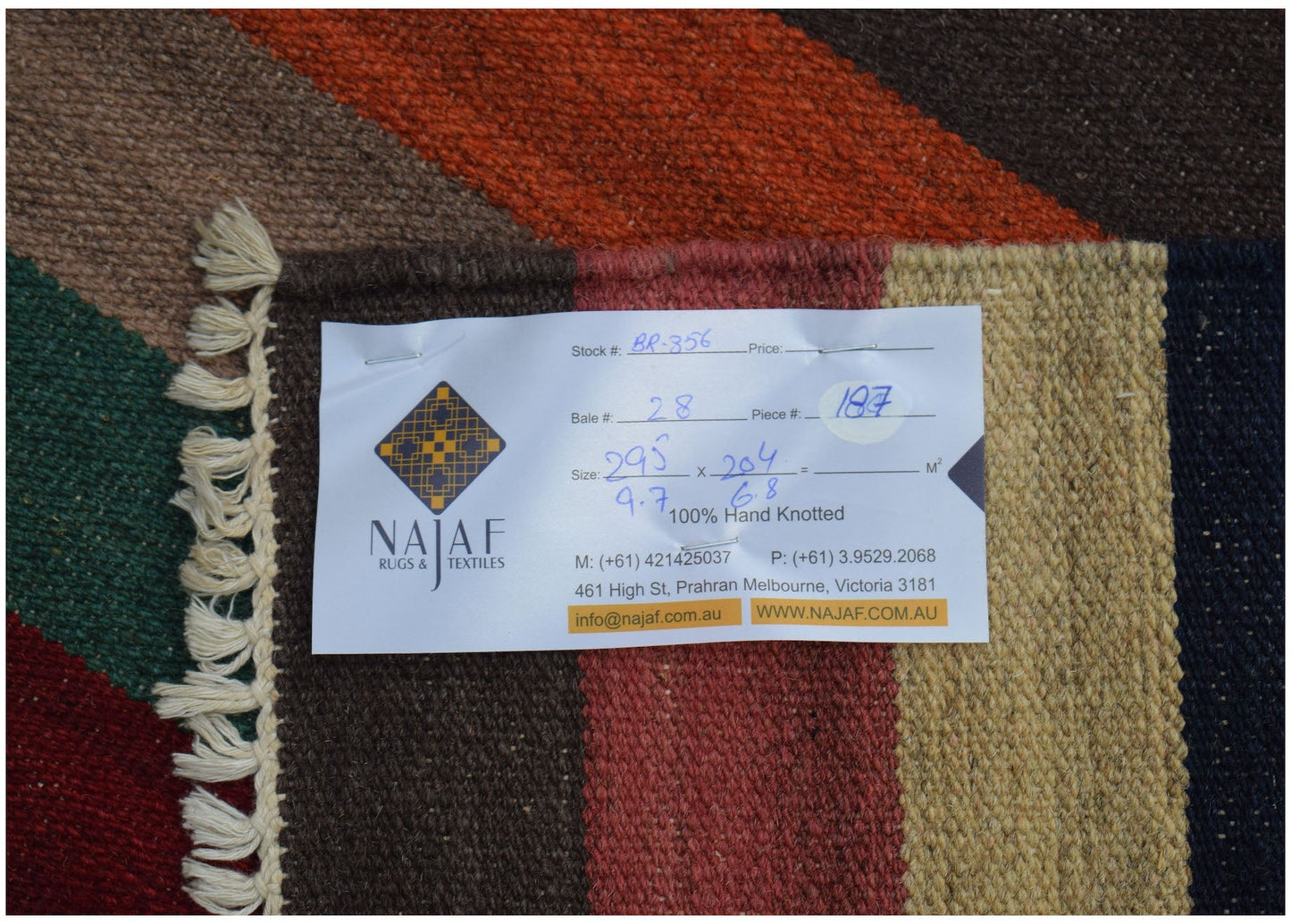 An Afghan Maimana Kilim rug featuring a geometric pattern in rich, warm colors.