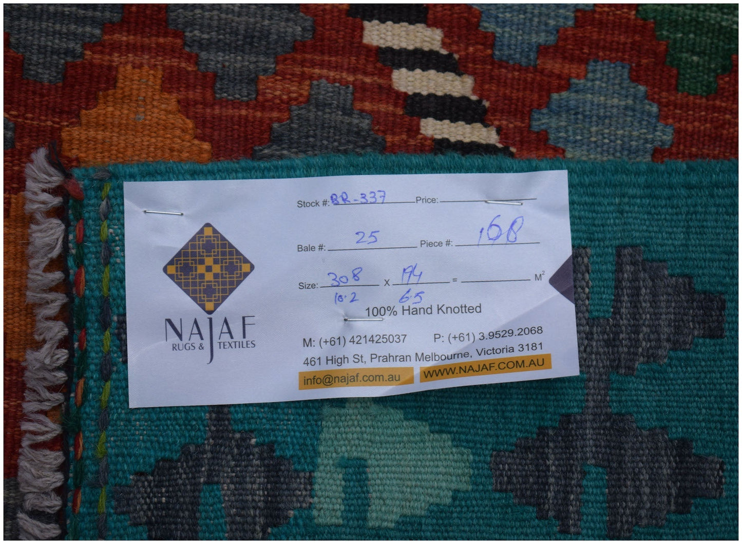 An Afghan Maimana kilim rug featuring a geometric pattern in vibrant colors.
