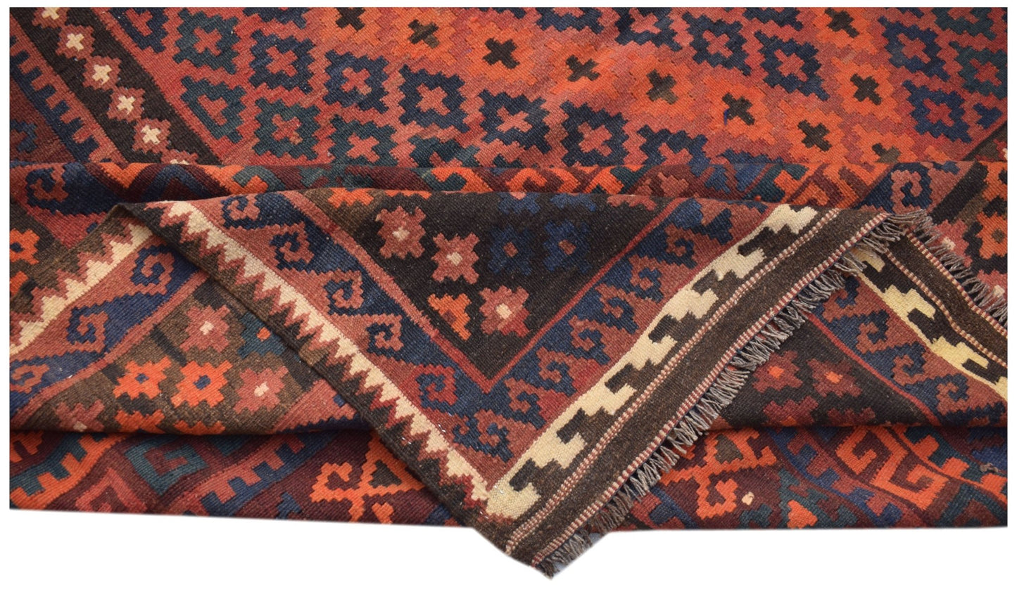Handwoven Afghan Maimana kilim rug featuring geometric patterns in red, blue, and cream wool.